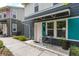 Charming townhouse featuring a covered entry, chairs, and well maintained landscaping at 2829 W 53Rd Ave # 104, Denver, CO 80221