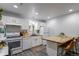 Modern kitchen with white cabinets, butcher block countertops, and breakfast bar seating at 2829 W 53Rd Ave # 104, Denver, CO 80221
