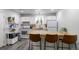 Well-lit kitchen featuring white cabinets, wood countertops, and modern appliances at 2829 W 53Rd Ave # 104, Denver, CO 80221