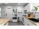 Functional kitchen with white cabinets, butcher block countertops, and ample storage at 2829 W 53Rd Ave # 104, Denver, CO 80221
