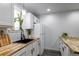 Bright kitchen featuring a sleek black sink, wooden counters, and white appliances at 2829 W 53Rd Ave # 104, Denver, CO 80221