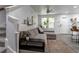 Comfortable living room with gray sofa, stylish rug, fan, and bright natural light at 2829 W 53Rd Ave # 104, Denver, CO 80221