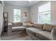 Inviting living room features a large, comfortable sectional couch and natural light from two large windows at 2829 W 53Rd Ave # 104, Denver, CO 80221