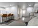 Open concept living room featuring a breakfast bar, gray sofa, and modern flooring at 2829 W 53Rd Ave # 104, Denver, CO 80221