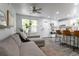 Bright living room flowing into a modern kitchen with breakfast bar seating at 2829 W 53Rd Ave # 104, Denver, CO 80221