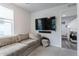 Relaxing living room boasts a large mounted television and comfortable sectional near a doorway at 2829 W 53Rd Ave # 104, Denver, CO 80221