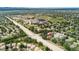 An aerial view shows a community surrounded by greenery, near a school and a wide main thoroughfare at 10294 Spotted Owl Ct, Highlands Ranch, CO 80129