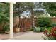 Shady backyard featuring a wooden swing beneath mature trees and lush landscaping at 10294 Spotted Owl Ct, Highlands Ranch, CO 80129