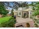 Fenced backyard with a covered patio, barbecue grill, and lush garden, perfect for outdoor living at 10294 Spotted Owl Ct, Highlands Ranch, CO 80129