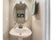 Bathroom featuring a pedestal sink, a large mirror and modern fixtures at 10294 Spotted Owl Ct, Highlands Ranch, CO 80129