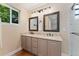 Bathroom featuring double vanity with stone countertop, undermount sinks, and updated lighting fixture at 10294 Spotted Owl Ct, Highlands Ranch, CO 80129