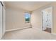 Neutral bedroom with tan carpet, a window looking out to the neighborhood, and a large closet at 10294 Spotted Owl Ct, Highlands Ranch, CO 80129