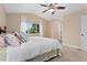 Bedroom with neutral walls, ceiling fan, and a bright window at 10294 Spotted Owl Ct, Highlands Ranch, CO 80129