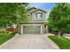 Charming two-story home featuring a well-maintained lawn and a two-car garage at 10294 Spotted Owl Ct, Highlands Ranch, CO 80129