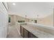 Hallway with carpet and overhead lighting featuring a granite countertop along the railing at 10294 Spotted Owl Ct, Highlands Ranch, CO 80129