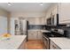 Kitchen featuring stainless steel appliances, a center island with granite countertops and gray cabinets at 10294 Spotted Owl Ct, Highlands Ranch, CO 80129
