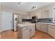 Updated kitchen with stainless steel appliances, a center island and gray cabinets at 10294 Spotted Owl Ct, Highlands Ranch, CO 80129
