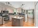 Open-concept kitchen features stainless appliances, island, and seamless access to the dining area at 10294 Spotted Owl Ct, Highlands Ranch, CO 80129