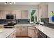 Modern kitchen showcasing gray cabinets, stainless steel appliances, and stylish subway tile backsplash at 10294 Spotted Owl Ct, Highlands Ranch, CO 80129