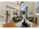 Bright living room boasts high ceilings, large windows, and a cozy fireplace at 10294 Spotted Owl Ct, Highlands Ranch, CO 80129