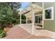 Covered patio with concrete and brick, outdoor grill, and view of the fenced backyard at 10294 Spotted Owl Ct, Highlands Ranch, CO 80129