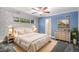 Serene bedroom with blue walls, soft lighting, and a view of the outdoors from the window at 3285 Balsam St, Wheat Ridge, CO 80033