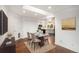 Sunlit dining area boasts modern lighting, and easy access to the renovated kitchen at 3285 Balsam St, Wheat Ridge, CO 80033