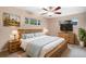Comfortable main bedroom with a ceiling fan, television, and relaxing light-toned color palette at 3285 Balsam St, Wheat Ridge, CO 80033
