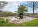 Backyard pond surrounded by stone, landscaping, and natural vegetation at 3285 Balsam St, Wheat Ridge, CO 80033