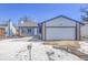 Brick ranch home with attached garage, and snow-covered front yard at 16851 E Mansfield Cir, Aurora, CO 80013