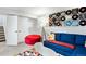 Finished basement with a blue couch and colorful decor at 5347 Osceola St, Denver, CO 80212