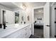 Bathroom featuring a double sink vanity and a view into a bedroom at 5347 Osceola St, Denver, CO 80212