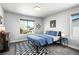 Bedroom with a window view and stylish blue bedding at 5347 Osceola St, Denver, CO 80212