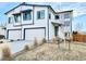 Charming two-story home with a three car garage and modern white and dark trim at 5347 Osceola St, Denver, CO 80212