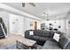Spacious living room with a large gray sectional, modern decor, and open access to the kitchen at 5347 Osceola St, Denver, CO 80212