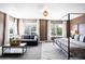 Spacious main bedroom with a sitting area, ample natural light, and a modern canopy bed at 5347 Osceola St, Denver, CO 80212