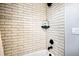 Tiled shower with shampoo niche and black fixtures at 5347 Osceola St, Denver, CO 80212