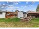 Large backyard with garden plots, shed, and plenty of green space for outdoor activities at 1492 S Cathay St, Aurora, CO 80017
