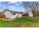Spacious backyard featuring a shed, green lawn, fence, and solar panels on the home at 1492 S Cathay St, Aurora, CO 80017