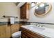 Stylish bathroom featuring marble countertops, wood accents, and a modern oval mirror at 1492 S Cathay St, Aurora, CO 80017