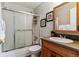 Clean bathroom with shower-tub combo, frosted doors, and neutral countertops at 1492 S Cathay St, Aurora, CO 80017