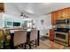 Bright dining area open to the living room and kitchen with bar stool seating at 1492 S Cathay St, Aurora, CO 80017