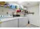 Functional laundry room with storage shelves, and full-sized washer and dryer units at 1492 S Cathay St, Aurora, CO 80017