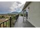 The back deck features scenic views of the mountains, city and nature, black iron railings, and leads to the interior at 265 Upper Glenway, Palmer Lake, CO 80133