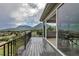 The back deck features scenic views of the mountains, city and nature, black iron railings, and a sliding glass door at 265 Upper Glenway, Palmer Lake, CO 80133