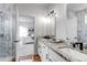 Bathroom featuring granite countertops, dual sinks, and marble tiled shower at 265 Upper Glenway, Palmer Lake, CO 80133