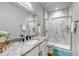 Elegant bathroom with granite countertop and a tiled walk-in shower at 265 Upper Glenway, Palmer Lake, CO 80133
