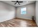 The bedroom has a window with natural light, wood floors, neutral walls and trim and a ceiling fan at 265 Upper Glenway, Palmer Lake, CO 80133