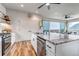 Spacious kitchen island featuring granite countertop, a sink, and stainless steel dishwasher at 265 Upper Glenway, Palmer Lake, CO 80133