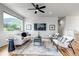 Comfortable living room features hardwood floors, a ceiling fan, a modern sofa and picturesque mountain views at 265 Upper Glenway, Palmer Lake, CO 80133
